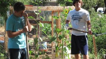 High school students prepared soil for future planting and learned about the importance of compost