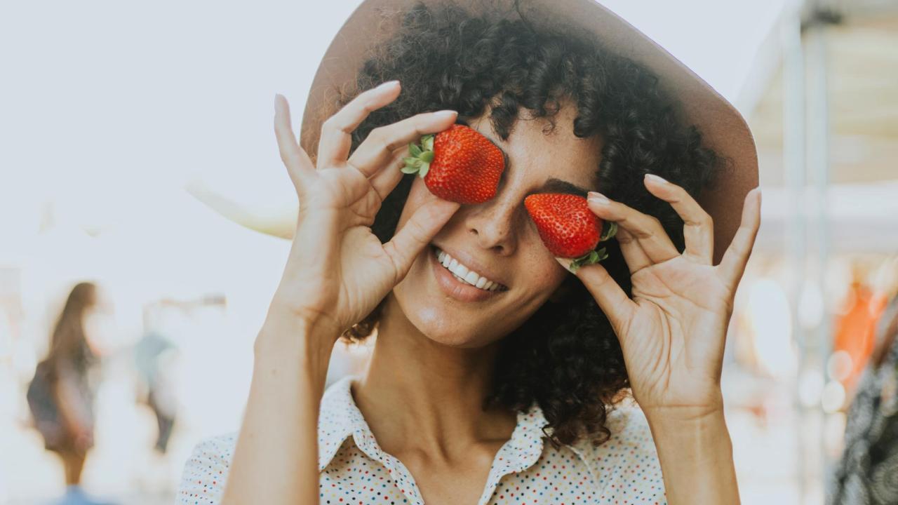 women holding strawberries 