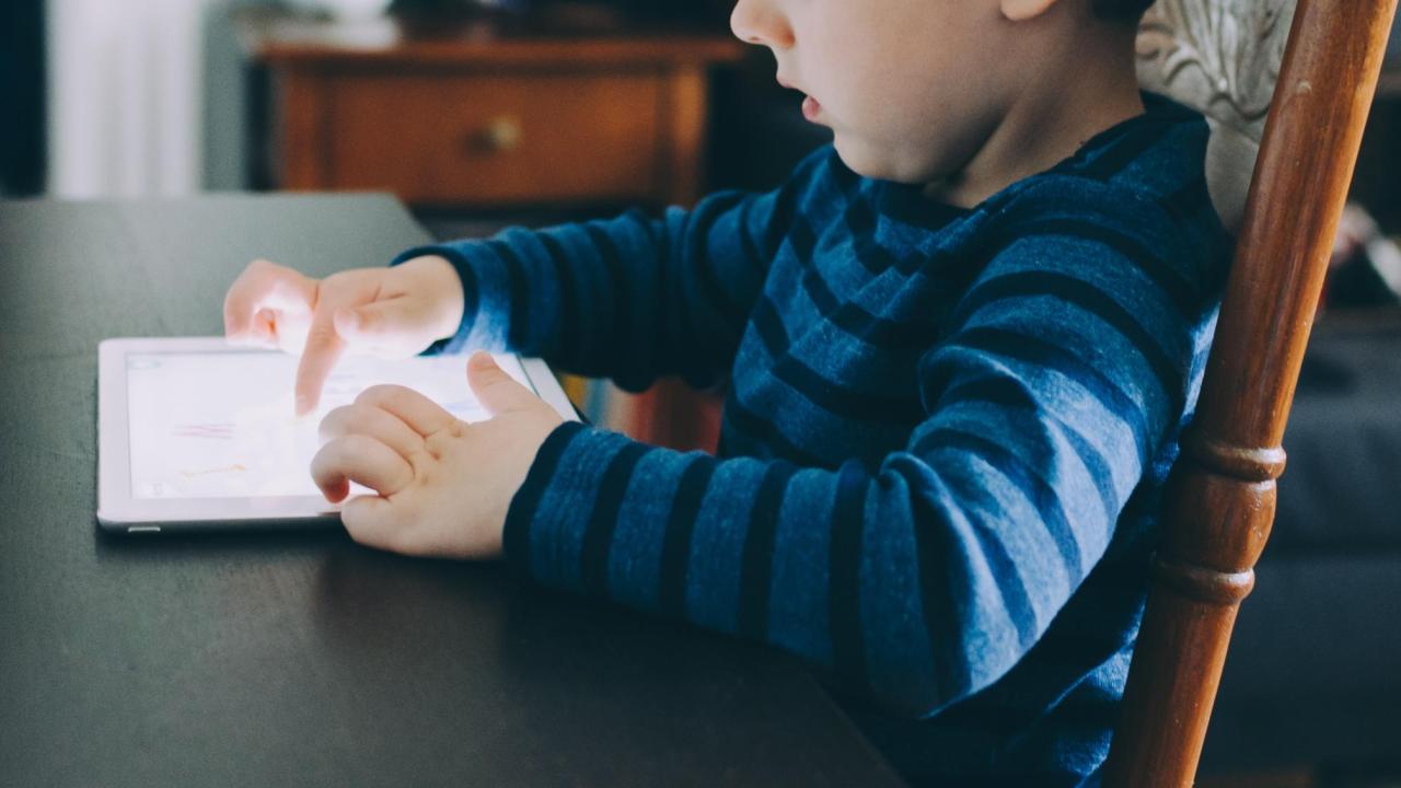 kid looking at a screen