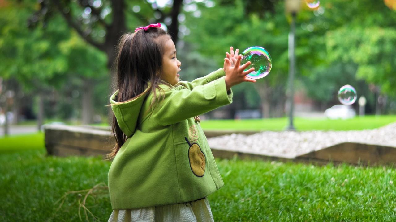 girl playing with bubbles