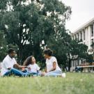 Family gathered around the grass outsided