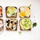 slices of bread topped with various fruit and vegetable toppings