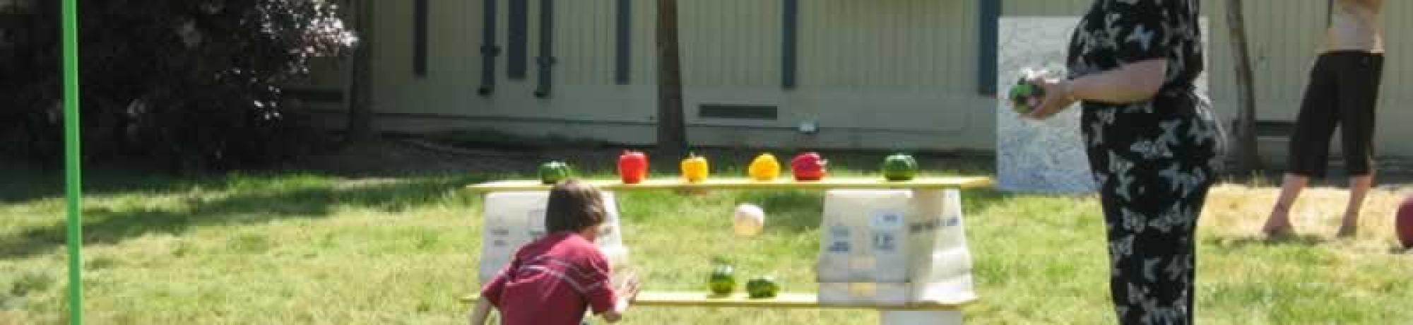 Kid playing with vegetables and fruits.